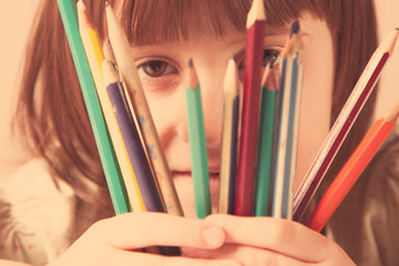 Art, creativity and education concept. Portrait of little cute child girl with colorful pens. Retro styled.