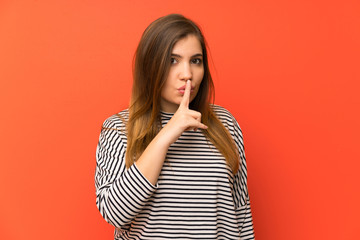 Young girl with striped shirt doing silence gesture