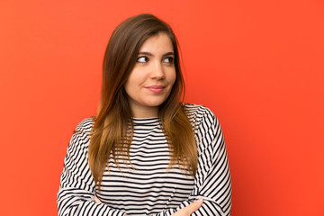 Fototapeta premium Young girl with striped shirt standing and looking to the side