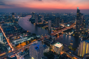 Fototapeta na wymiar Aerial view of epic sunset sky above Bangkok cityscape and Chao Phraya river