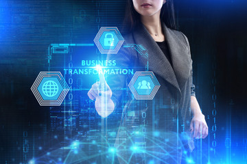 The concept of business, technology, the Internet and the network. A young entrepreneur working on a virtual screen of the future and sees the inscription: Business transformation