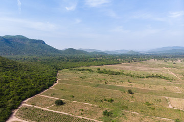 Fototapeta na wymiar Drone shot aerial view scenic landscape of agriculture farm against mountain and nature forest