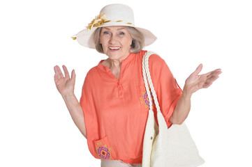 Beautiful senior woman in white hat on white background. Travel concept