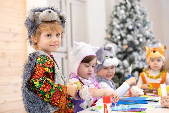 Children Handiwork In Kids Club. Craft Lesson In Primary School. Kid Boy Together His Friends Weared Animal Costumes In Class. Group Of Kindergarten Childs Work Preparing To Christmas