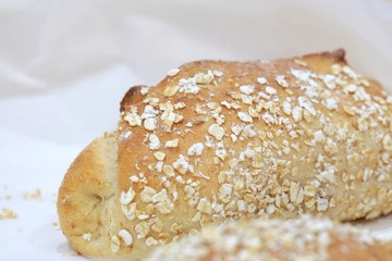 Close up fresh wholewheat breads in a basket on a dining table 