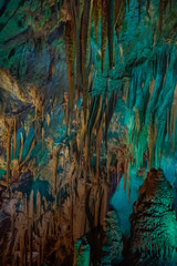 illuminated stalagtites in Prometheus Cave
