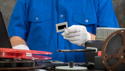 technician with white gloves digitizing old 35mm film slide