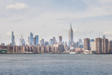 Naklejka premium View of Manhattan buildings and river from Brooklyn neighborhood in New York.