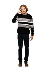 Fototapeta premium Full-length shot of Blonde man making the gesture of madness putting finger on the head over isolated white background