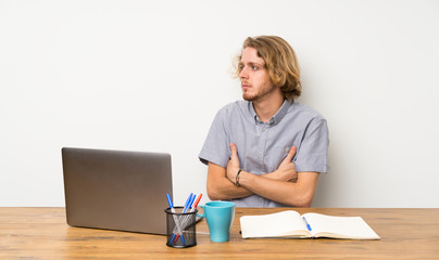 Blonde man with a laptop portrait