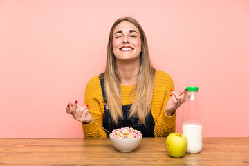 Young woman with bowl of cereals laughing