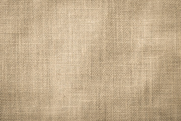 Hessian sackcloth woven texture pattern background in light cream yellow beige