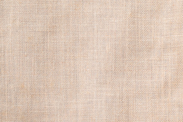 Hessian sackcloth woven texture pattern background in light cream beige brown color