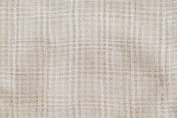 Hessian sackcloth woven fabric texture background in beige cream color