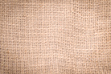 Fototapeta na wymiar Hessian sackcloth woven texture pattern background in light cream beige brown color tone