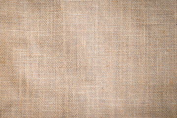 Hessian sackcloth woven texture pattern background in light sepia tan beige cream brown color