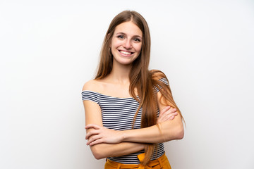 Young woman with long hair over isolated white wall keeping the arms crossed in frontal position
