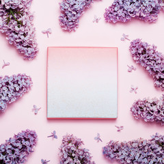 Lilac holiday background with place for text. Top view, flat lay of beautiful spring flower background.