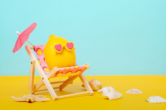 Lemon in sunglasses in the sunbed with umbrela