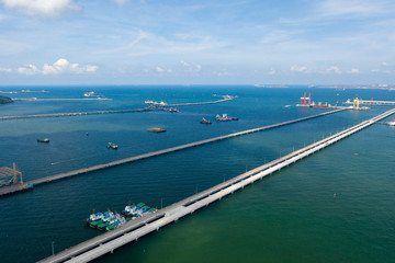Fototapeta na wymiar Aerial view. Container ship in pier with crane bridge carries out export and import business in the open sea. Logistics and transportation