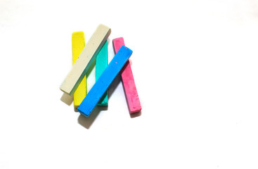 Colored chalk for drawing on a white wood background. Concept-ready to scool