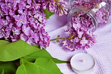 Obraz na płótnie Canvas Lilac flowers in a jar on the table.Preparation of tincture of lilac to strengthen the immune system and improve the body.