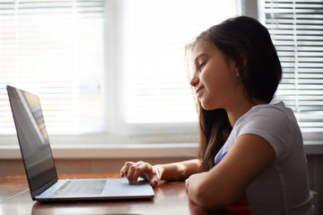 Modern children girl using laptop