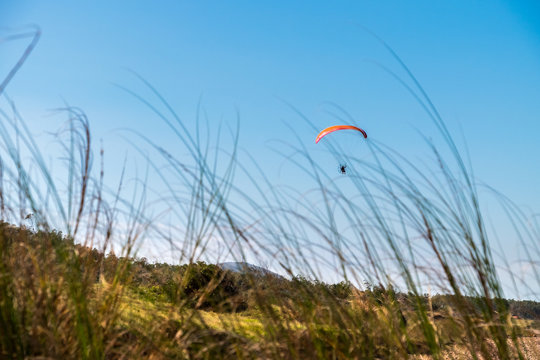 Parasailing over Las Flores Beach, on a very hot day during the summer at Maldonado, Uruguay.