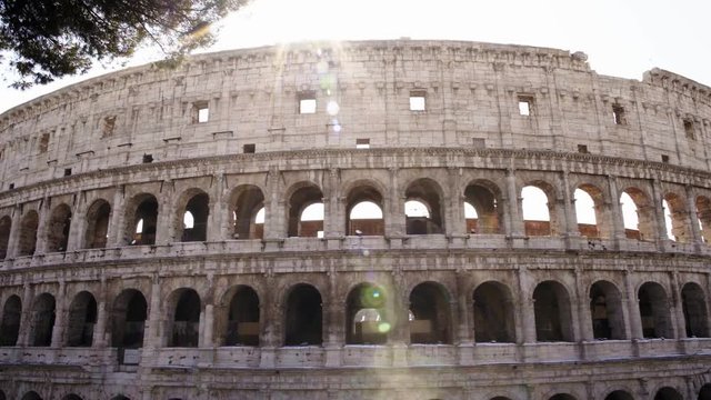 Left to right pan shot of Colosseo in Rome. The Colosseum also known as the Flavian Amphitheatre, an oval amphitheatre in the centre of the city of Rome.