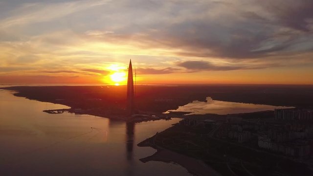 aerial view of sunset Lakhta center, bridge cars the tallest building in Europe, the business centre, the Zenit arena is the Gulf of Finland in St. Petersburg, Russia