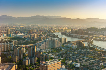 Obraz premium Golden summer light sunset skyline. with a view of fukuoka downtown city cityscape, Fukuoka, Japan