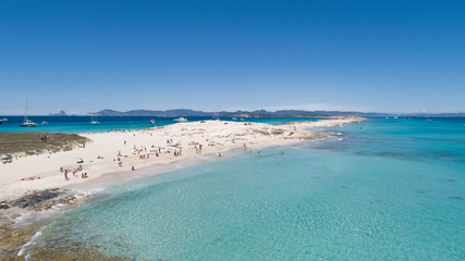 illetas, formentera beach seen from drone with turquoise and crystalline sea and Ibiza in the...