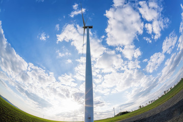 Wind turbines against blue sky during sunrise