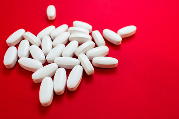  White pills on red background