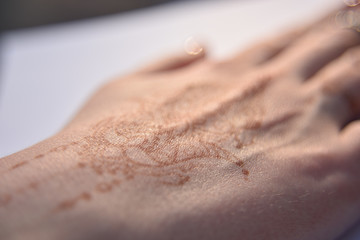 Mehendi pattern on woman's hand