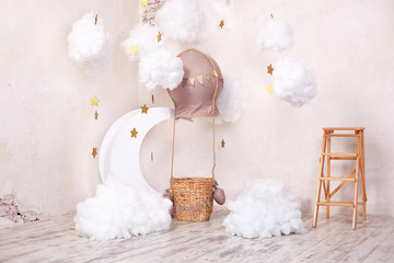 Stylish vintage children's room with aerostat, balloon and textile clouds. Children's location for a photo shoot: aerostat, balloon and clouds. Place for a dream. Little traveler and pilot. decor 