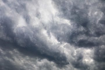 Dramatic dark clouds on blue sky background and texture