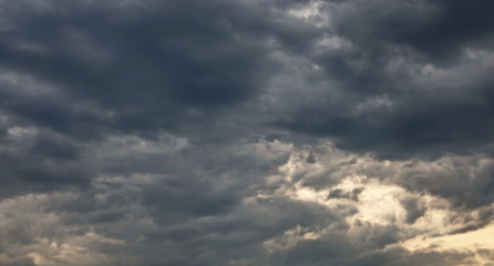 Fototapeta premium Dramatic dark clouds on blue sky background and texture
