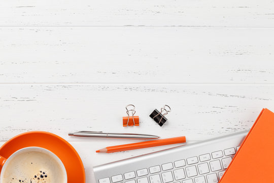 Office workplace with coffee, supplies and computer