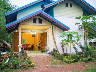 Wooden house with an an open door in Thailand