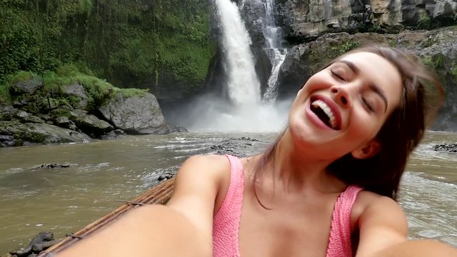  Beautiful girl having fun at the waterfalls in Bali