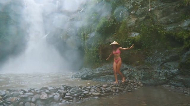  Beautiful girl having fun at the waterfalls in Bali