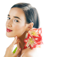 Fototapeta na wymiar young pretty brunette real woman with red flower amaryllis close up isolated on white background. Fancy fashion makeup, bright lipstick, creative Ombre manicured nails