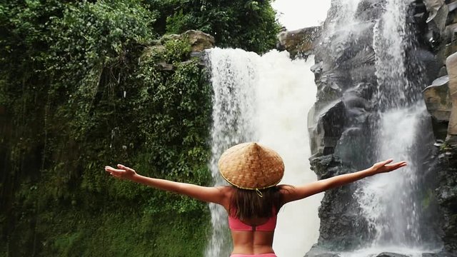  Beautiful girl having fun at the waterfalls in Bali