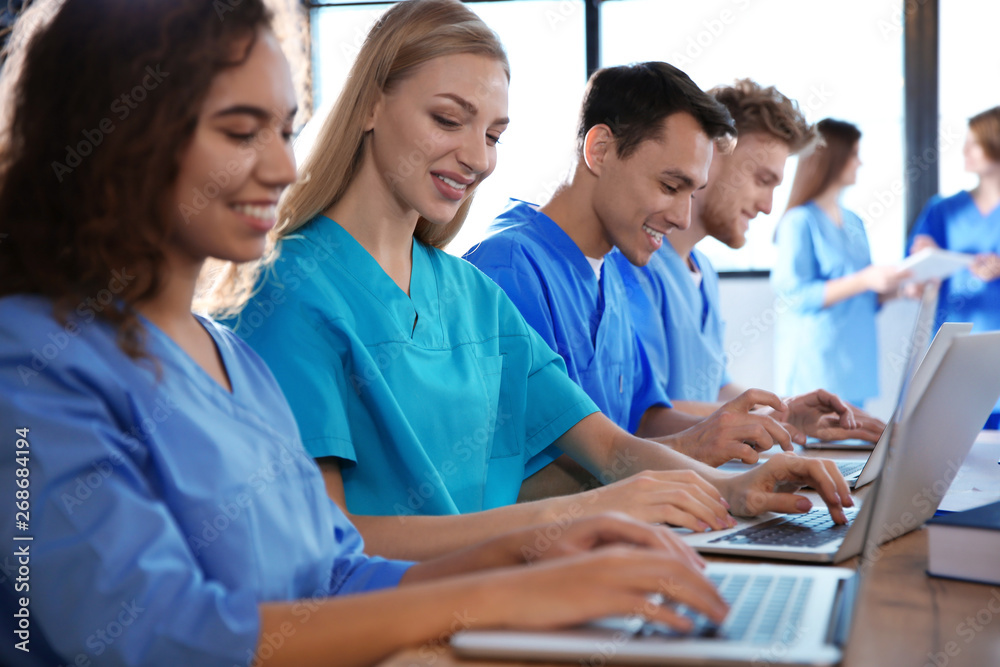 Poster Group of smart medical students with gadgets in college