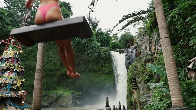 Beautiful girl having fun at the waterfalls in Bali. Concept about wanderlust traveling and wilderness culture
