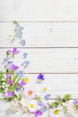 beautiful flowers on wooden background