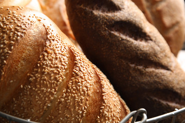 Different kinds of fresh bread in basket, closeup
