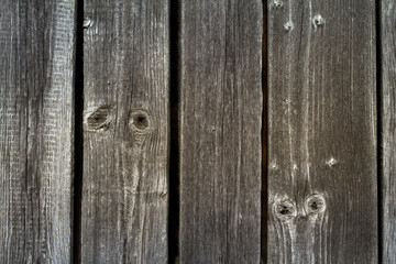 Background of old peeled cracked wood, stacked old boards