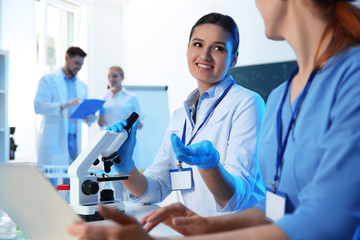 Group of scientists working in modern chemistry laboratory